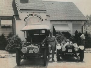 James Melton outside the Melton Museum (Norwalk, Conn.) standing between his 1907 Rolls Royce and 1914 Mercer Raceabout.